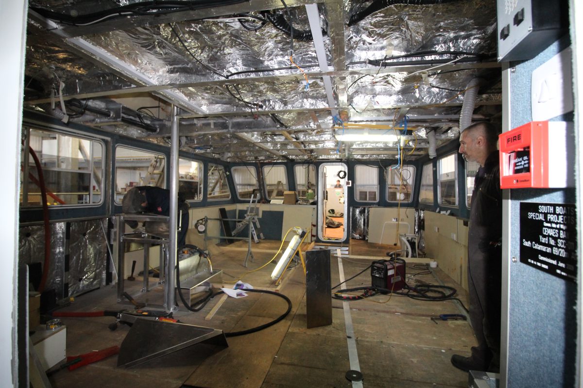 fitter surveying progress of interior