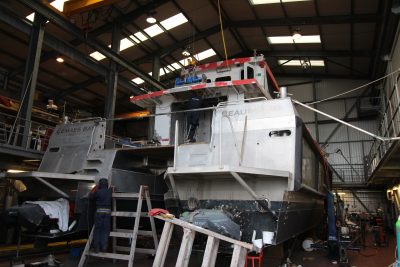Boat builders welding the stern